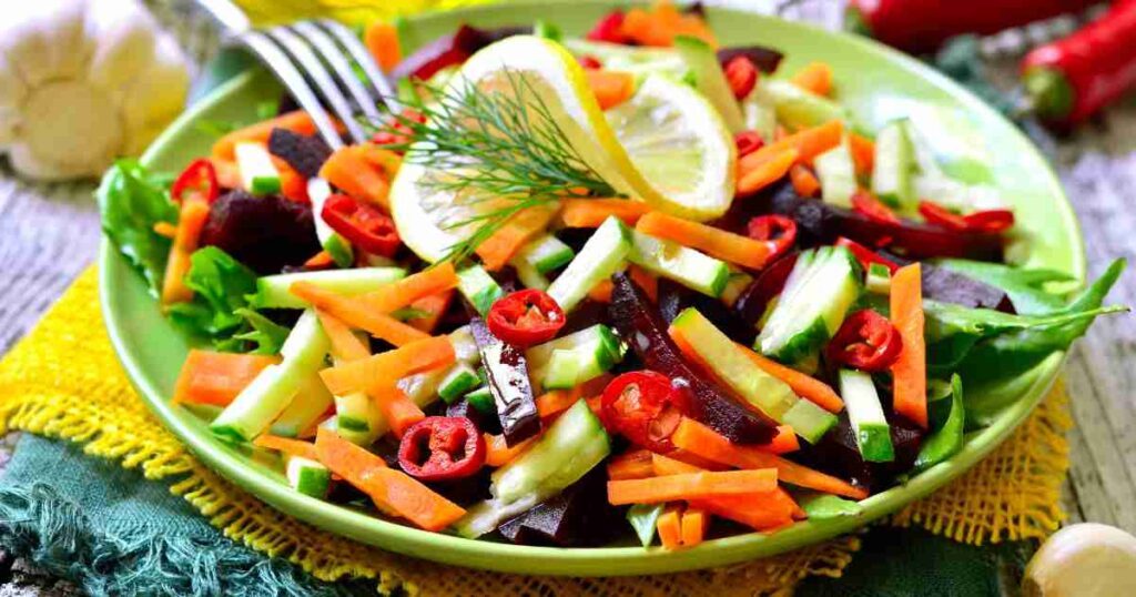 A vibrant Carrot Cucumber Salad bowl with Citrus Dressing on a wooden table. refreshing carrot cucumber salad with citrus dressing Refreshing Carrot Cucumber Salad with Citrus Dressing Carrot Cucumber Salad recipe1 1024x538
