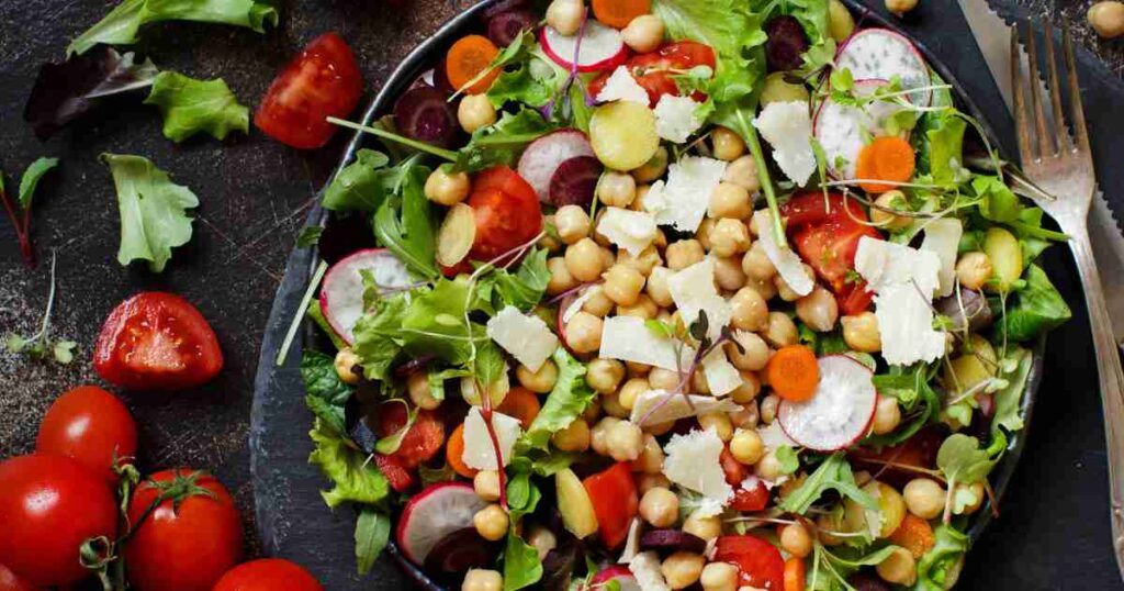 A bowl of colorful Mediterranean Chickpea Salad, bursting with fresh vegetables and herbs. chickpea salad Mediterranean Chickpea Salad Chickpea Salad 1024x538