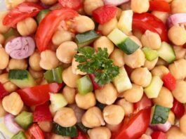 A bowl of colorful Mediterranean Chickpea Salad, bursting with fresh vegetables and herbs.