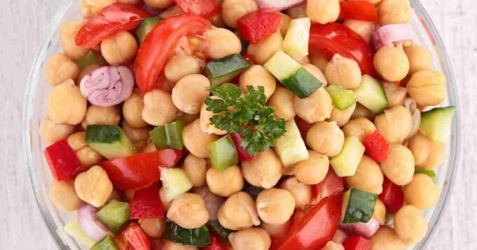A bowl of colorful Mediterranean Chickpea Salad, bursting with fresh vegetables and herbs.