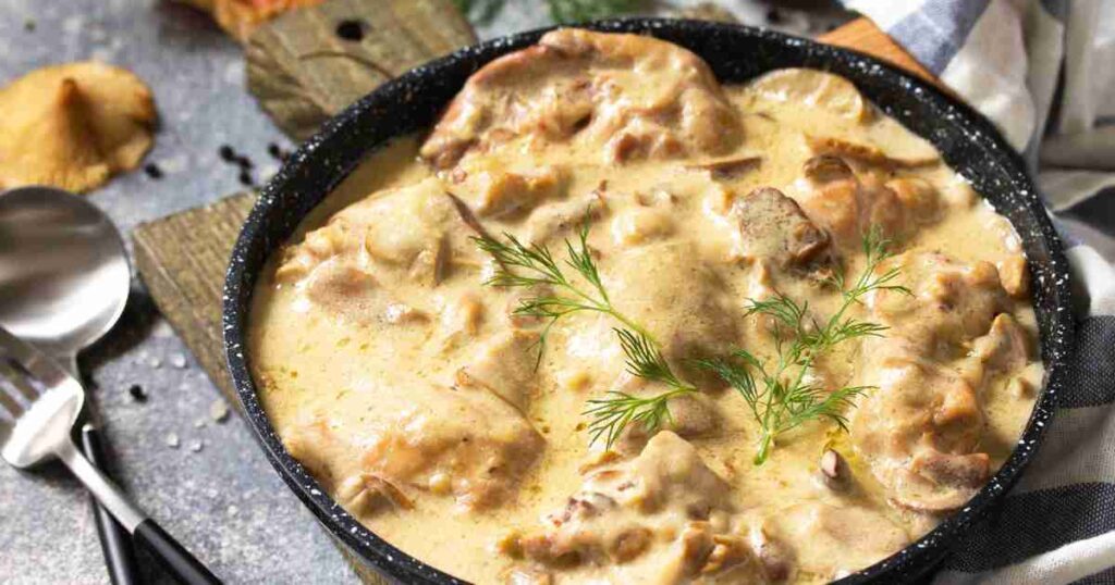 A skillet filled with creamy chicken and mushrooms garnished with fresh herbs. creamy chicken and mushrooms Creamy Chicken and Mushrooms Creamy Chicken and Mushrooms1 1024x538