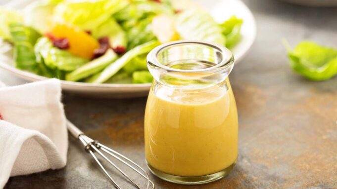 Freshly prepared Classic Caesar Salad with Homemade Lemon Vinaigrette on a white plate.