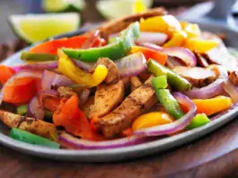 Colorful and appetizing Sheet Pan Chicken Fajita Bowls served on a white plate.