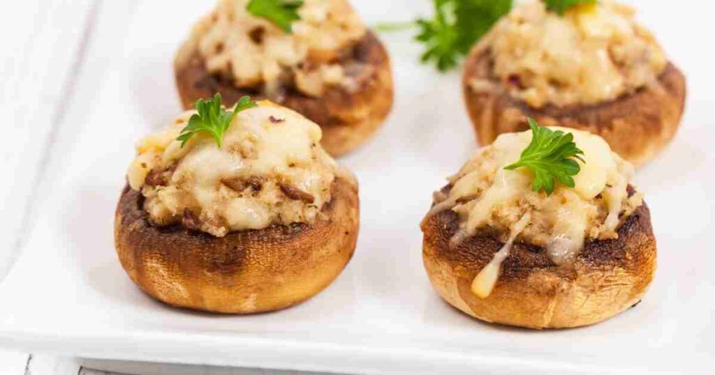 Golden-browned stuffed mushrooms filled with a savory mixture of herbs, cheese, and breadcrumbs on a white serving platter. Stuffed Mushrooms: A Versatile Appetizer for Every Occasion Stuffed Mushrooms: A Versatile Appetizer for Every Occasion Stuffed Mushrooms1 1024x538