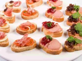 Elegant Tuna Spread Canapés on a serving platter, garnished with fresh herbs.