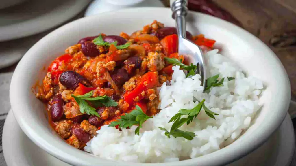 A bowl of hearty and healthy chilli con carne garnished with fresh herbs. healthy chilli con carne Healthy Chilli Con Carne Healthy Chilli Con Carne1 1024x576