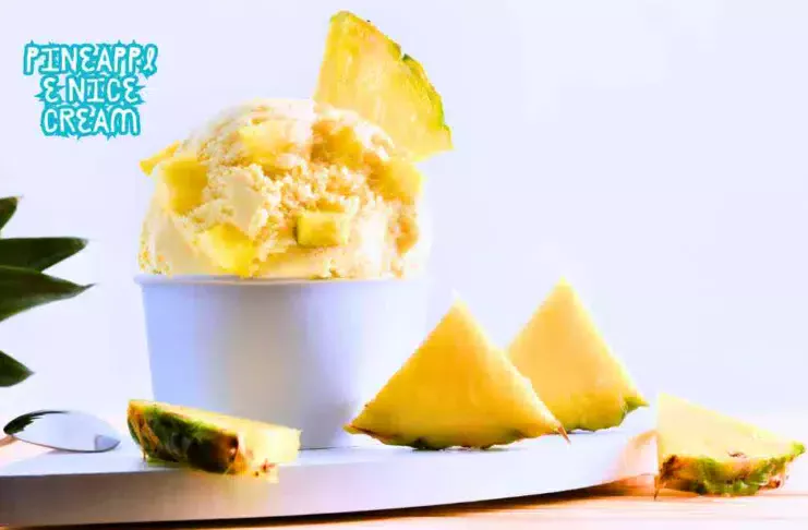 A bowl of creamy Pineapple Nice Cream topped with fresh pineapple chunks and mint leaves.